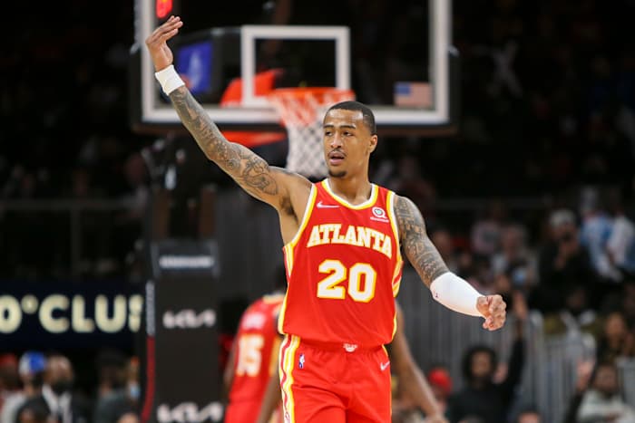 John Collins waves to the fans during a game.